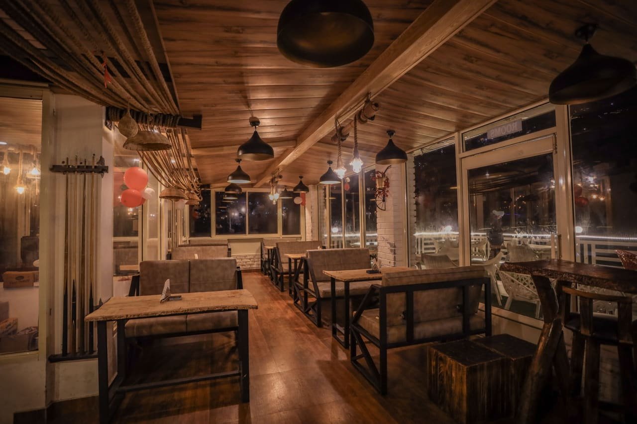 Long dining room under a timber ceiling
