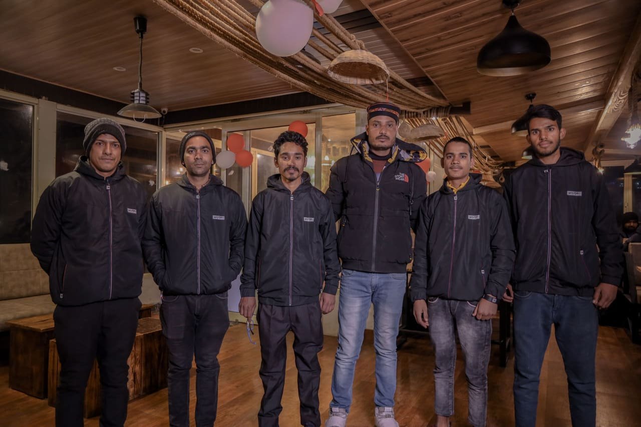 The SevenZ team at the restaurant entrance