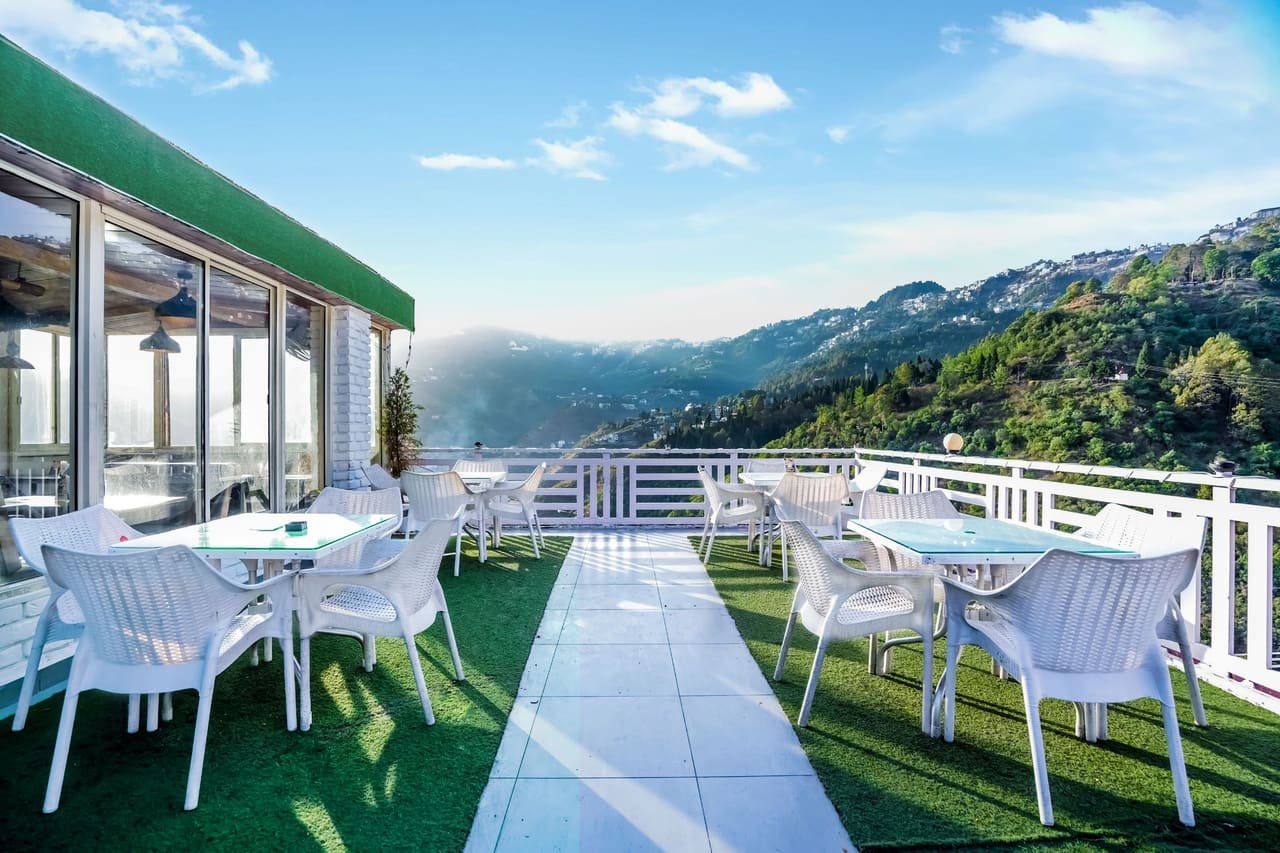 Daytime rooftop seating under a blue sky