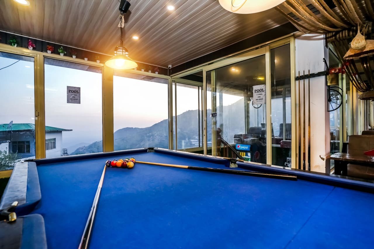 Pool table beside the valley-facing glass