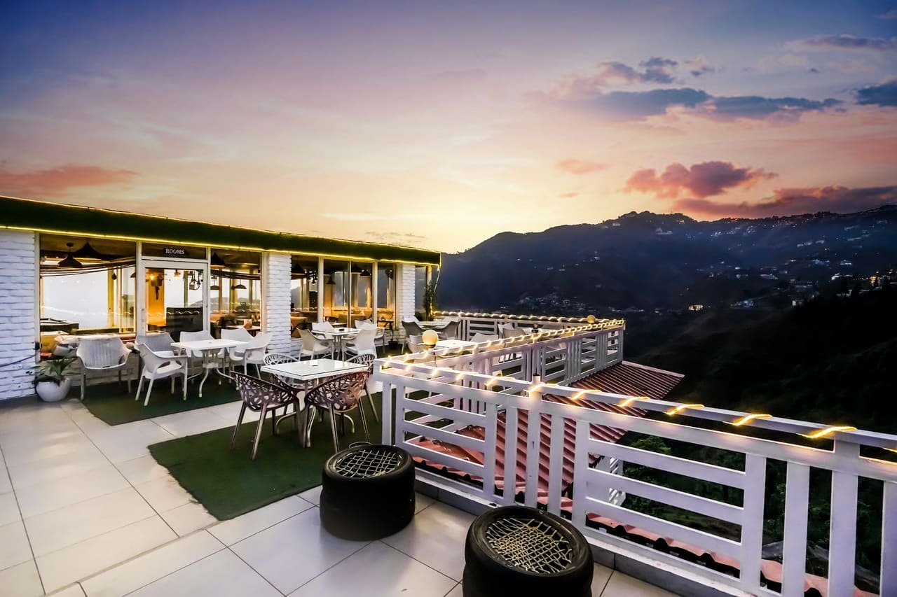 Rooftop terrace at SevenZ looking out over the Mussoorie hills at sunset